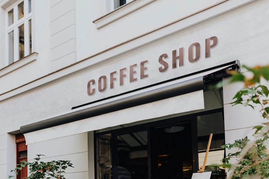 A coffee shop facade on a sunny day.